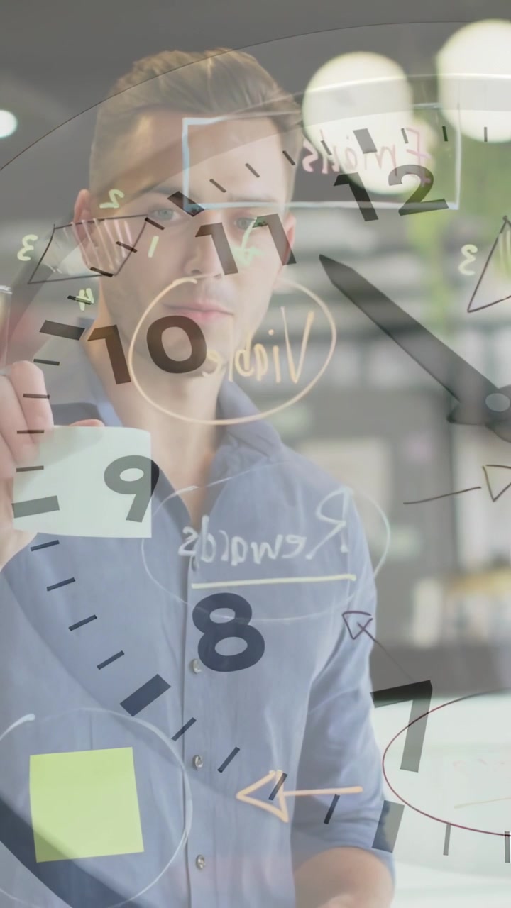Male holding sticky note as team writing on glass, drawing arrows business plan, clock dial overlay
