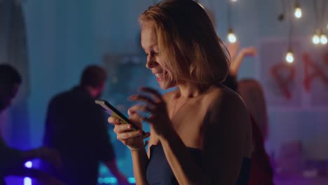woman texting at a party
