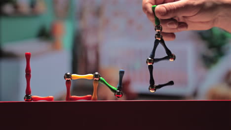 magnetic sticks and balls toy spell out love - concept