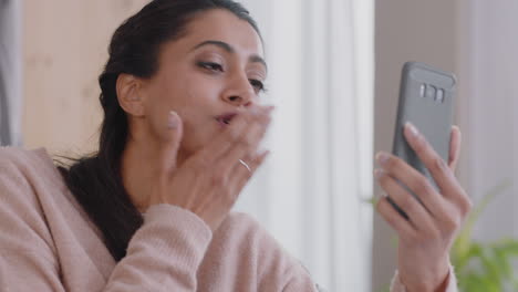 happy-indian-woman-having-video-chat-using-smartphone-waving-at-baby-blowing-kiss-enjoying-chatting-on-mobile-phone-at-home