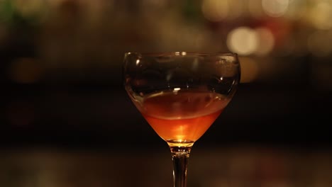 steady view of a cocktail glass with a blurred background