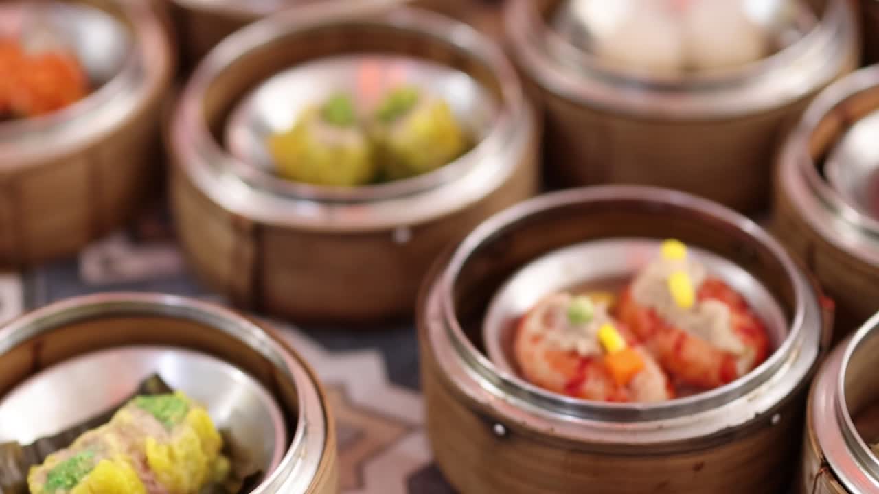 A vibrant array of dim sum dishes presented in bamboo steamers, showcasing a variety of colors and textures.