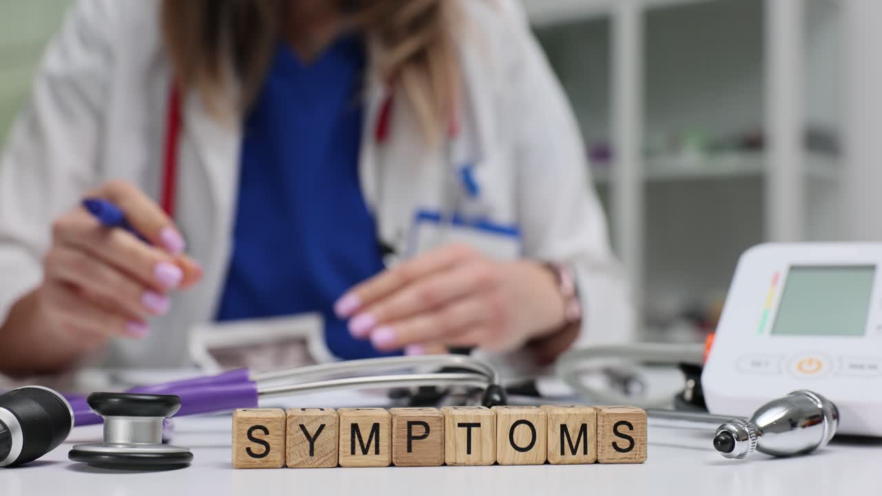 Wooden blocks show symptoms near woman medical writing at desk