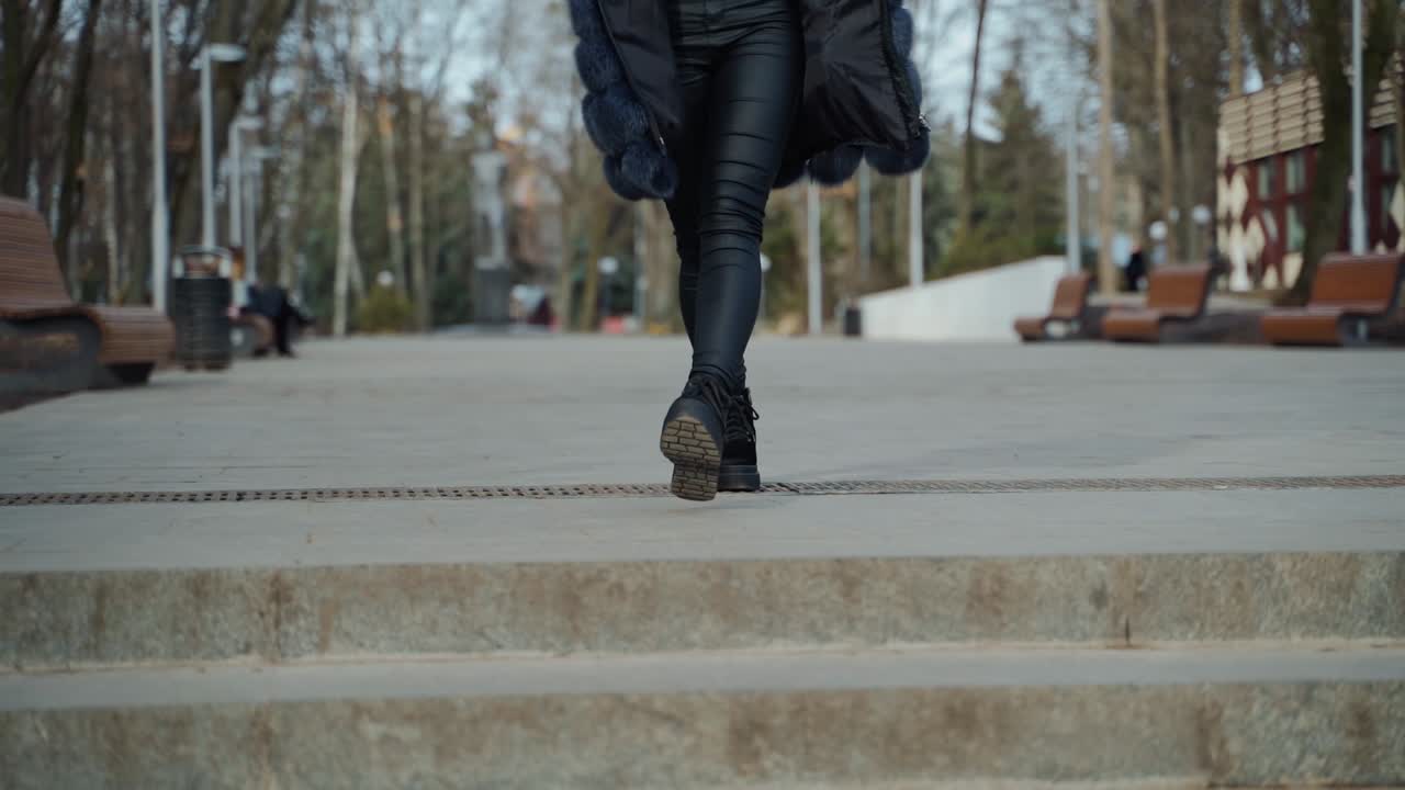 Beautiful woman walking in park. Close up of woman in casual clothes posing outdoors