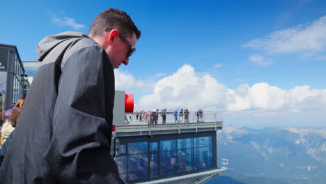 Visitors-can-be-seen-at-the-chairlift-station-positioned-atop-the-hill