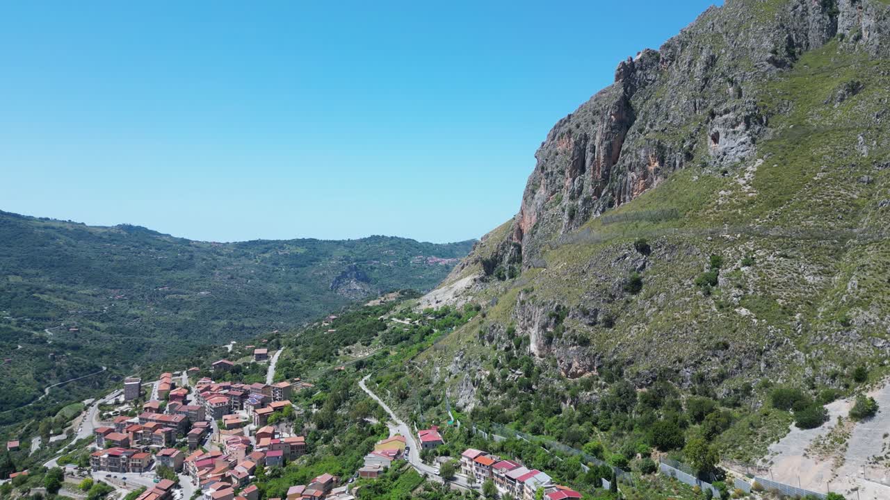 Aerial drone footage of Alcara Li Fusi, Sicily: mountain village, rocky peaks, lush valleys and wild Nebrodi landscapes. Ideal for travel, nature and scenic stock footage