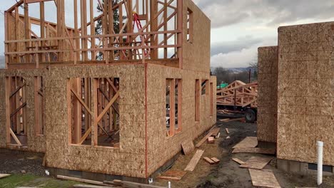 Wooden-walls-in-construction-with-windows-and-excess-pieces