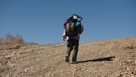 person hiking up a mountain trail