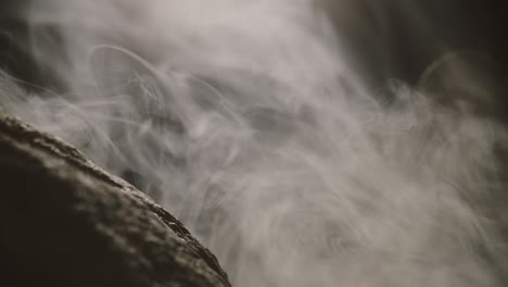 close up view of rocks in the smoke, mountains at night