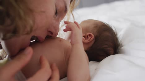 video of happy caucasian mother kissing newborn baby