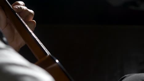 close-up of a person playing an acoustic guitar