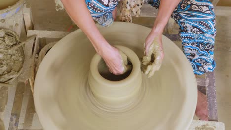 sculpt molding a pottery pot with patience top down shot