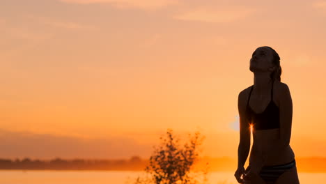 Serve-reception-volleyball-beautiful-woman-in-bikini-on-beach-at-sunset.