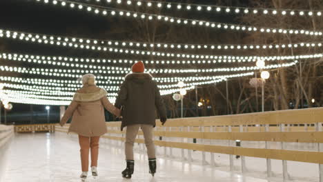 couple ice skating at night