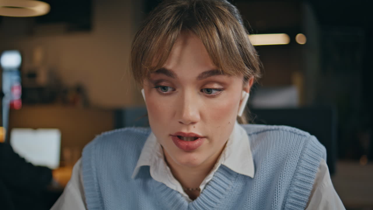 Closeup earphones businesswoman talking laptop at cabinet. Woman video calling