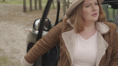 Red-Haired-Woman-Is-Lost-With-Her-Car-In-The-Middle-Of-The-Countryside-1