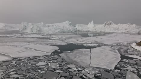 drone over sea and ice of ilulissat icefjord