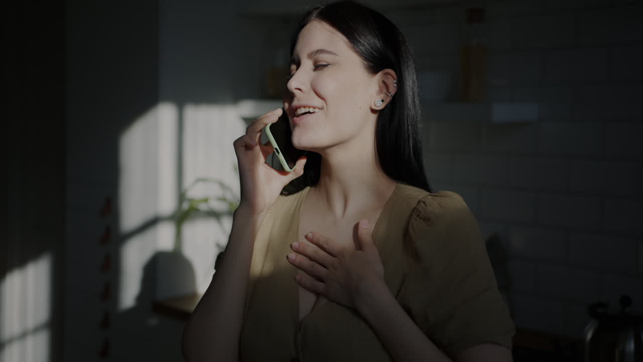 Woman on phone call in kitchen