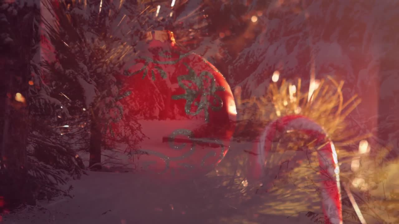 Animation af julepynt over vinterlandskab med grantræer.