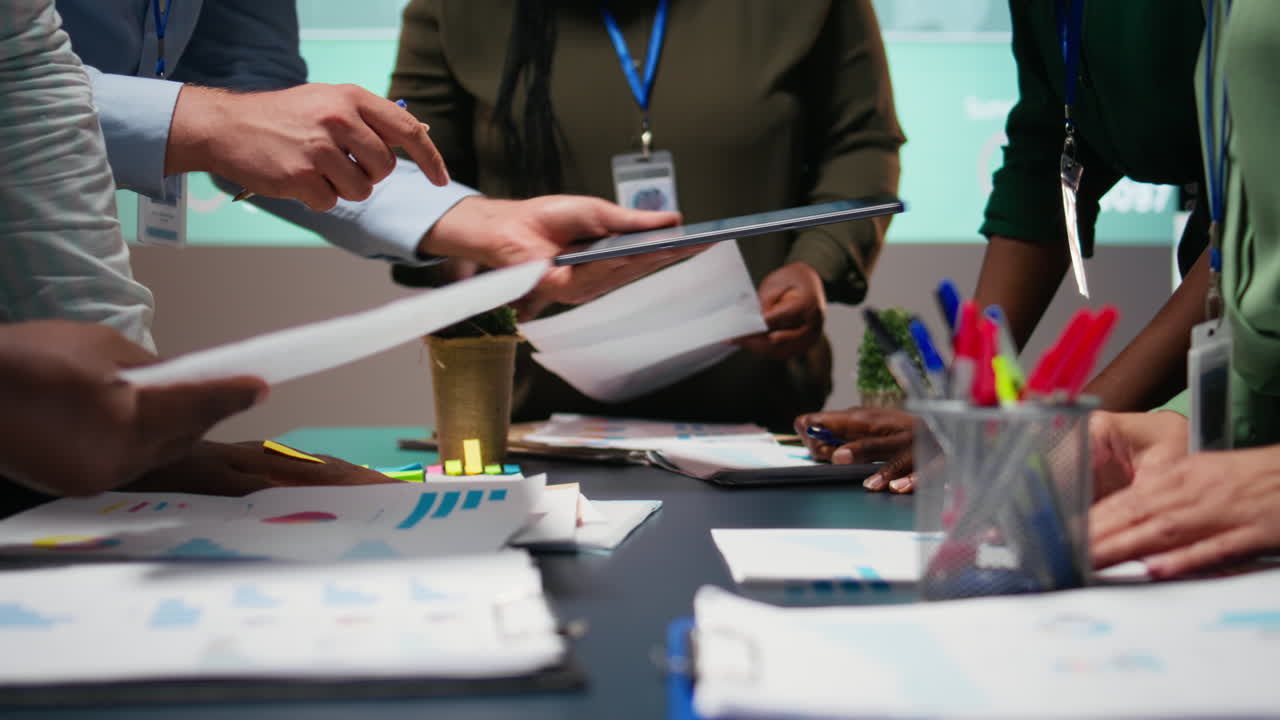 Diverse business team exchanging insights and forecasting diagrams