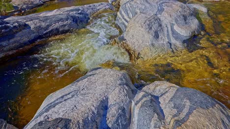 Sunrise-tilt-up-over-golden-Sabino-Creek,-Sabino-Falls-and-saguaro-laden-hills-in-Sabino-Canyon,-Arizona