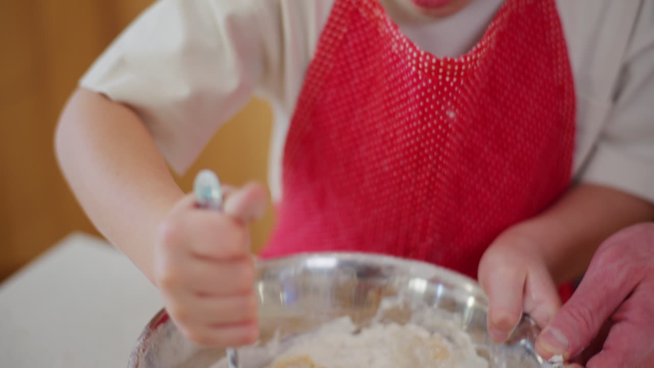 Boy Mixing Dough In A Bowl And Helping Dad Bake