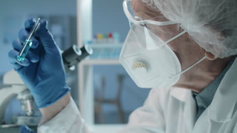 senior lab scientist examining liquid in test tube