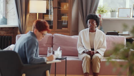 unhappy black woman talking to counseling psychologist