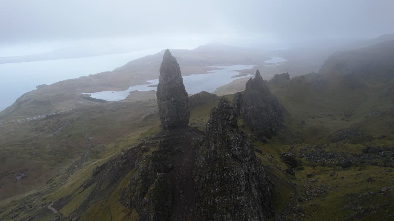 Epic aerial tilt panoramic view of the old man of Storr in the clouds on isle of Skye