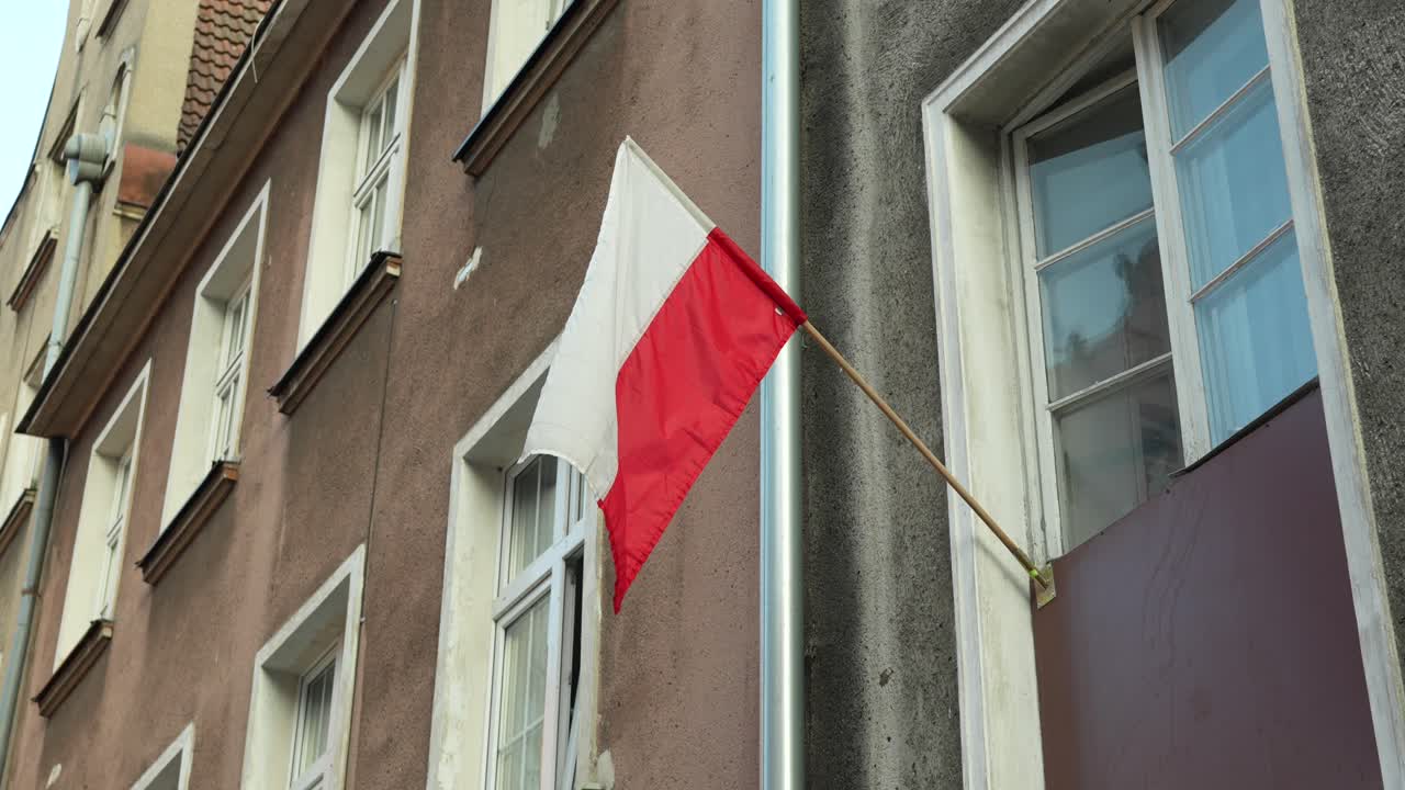 Polish flag on old building in Gdansk city centre. National holiday and pride
