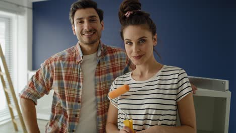 video portrait of young couple ready to paint a room.