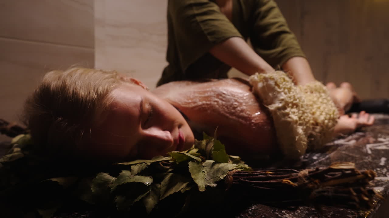 Woman receiving a traditional body scrub in a spa