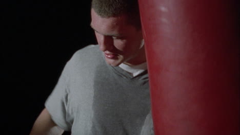 a man hits a punching bag