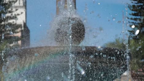 tilt from bottom to top of a water fountain in the park