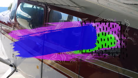 on tarmac, animation of colorful abstract patterns overlaying small aircraft