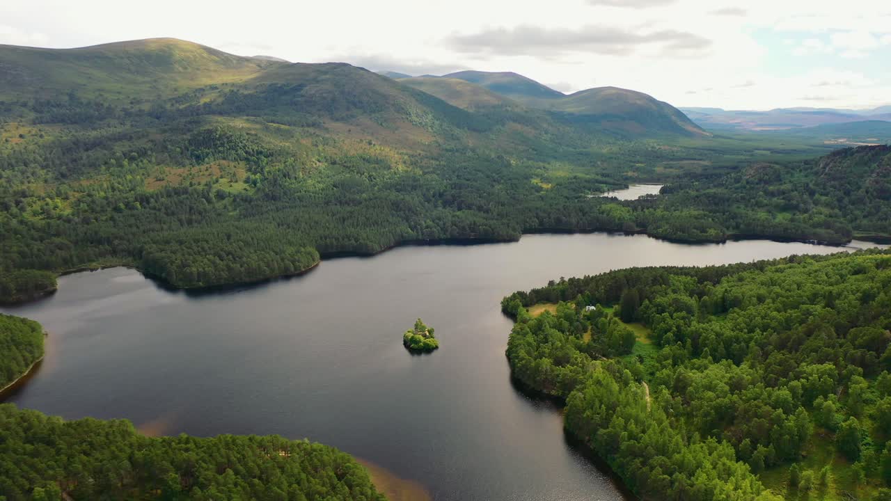 aviemore aerial majesty: timeless loch an eilein and castle overlooked by a scots pine forest canopy, cairngorms, scottish highlands