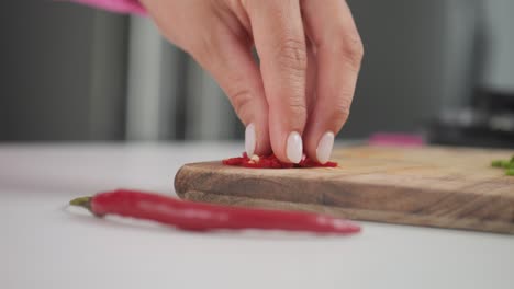 Spicy-hot-red-peppers,-close-up-ingredients-on-cutting-board