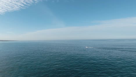 watch a boat riding in amazing sea at cascais