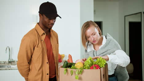 Woman-receiving-box-of-vegetables