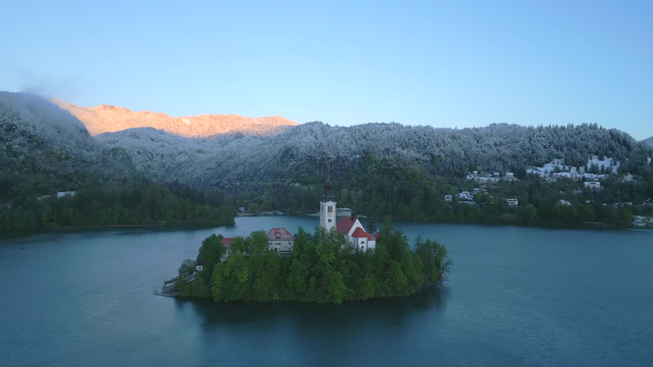 Slovenian lake bled near the alpine peaks with jamnik church