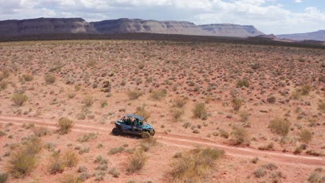 shot of dune buggy driving through utah's desert wasteland