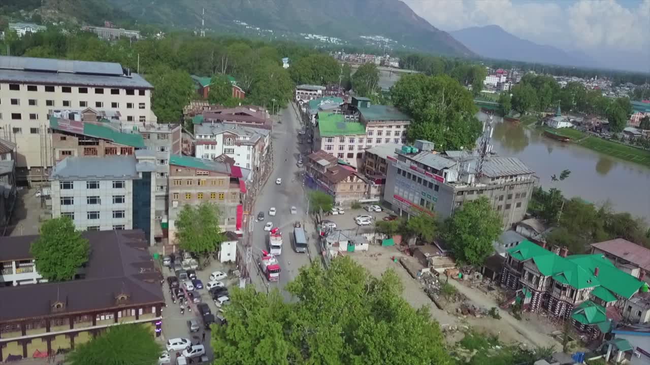 Drone videos of covid fumigation vehicles trucks and frontline heroes wearing  white kits on streets empty roads of srinagar India.