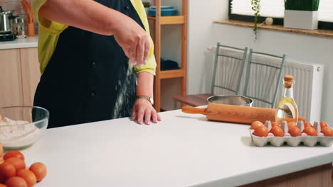 Close-up-of-hand-sieving-flour