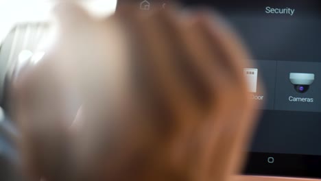 Close-up-of-a-woman's-finger-using-a-digital-interface-to-open-garage-door,-smart-housing