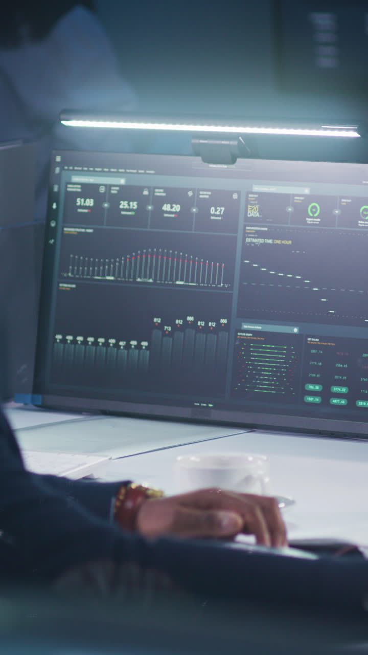 Person Working on Computer with Data Screens