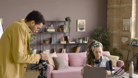 Woman-Sitting-On-A-Table-With-Laptop-And-Microphone-To-Recording-A-Podcast