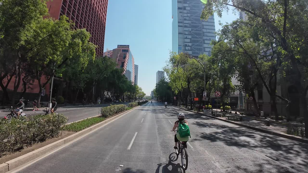 Shot of a woman with her bicycle in reforma avenue mexico city