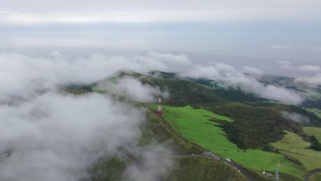 Aerial-view-of-green-landscape-near-Lagoa-do-Fogo-with-low-clouds---drone-shot