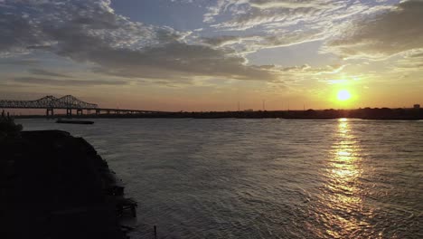 aerial video of push boats and barge on the mississippi river in the mornings beautiful sunrise