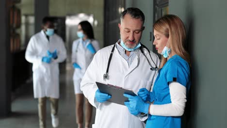 caucasian doctors, male and female, talking